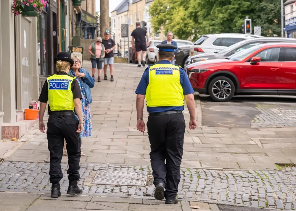 Police officers on a neighbourhood patrol walking through town to engage with residents and provide a police presence.